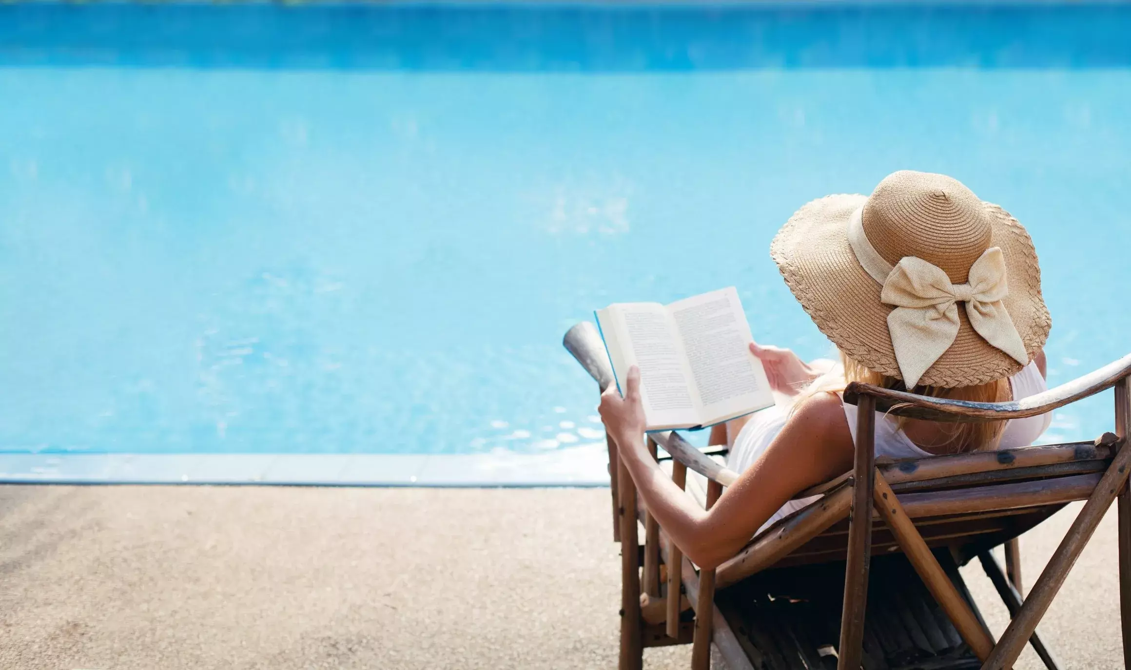 woman reading at pool